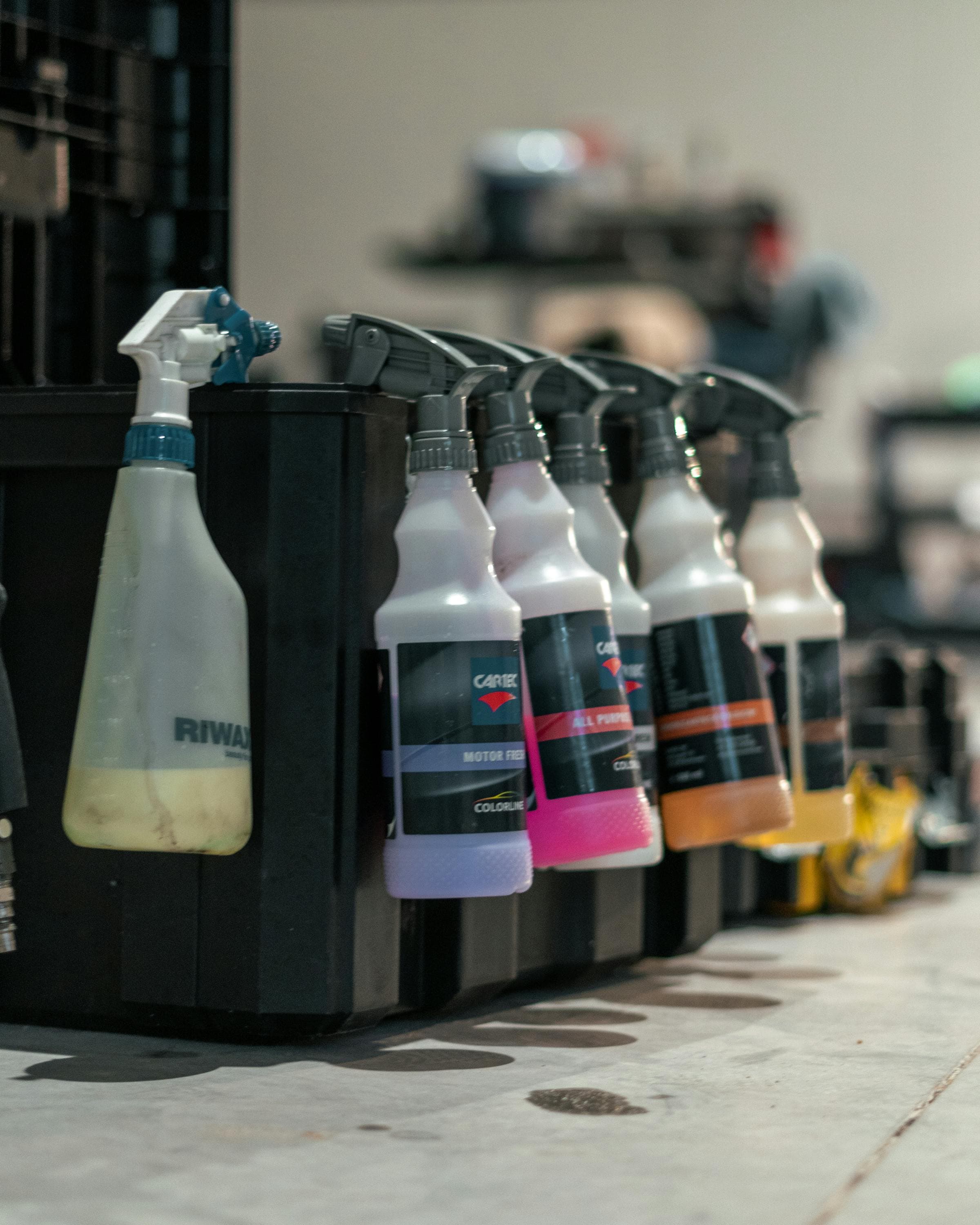 Workshop cleaning and care products arranged on a service bench